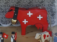 Eine in den Schweizer Nationalfarben gehaltene Kuh in einem Schaufenster.